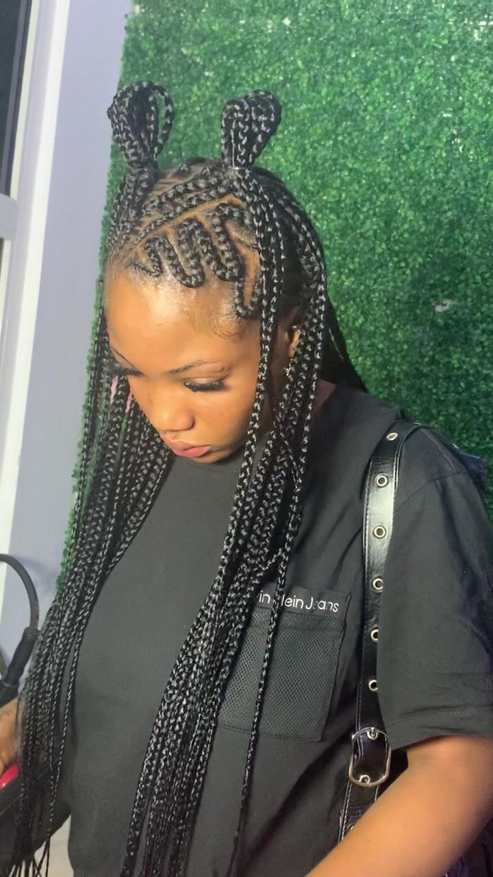 Long knotless braids with a styled parting, done at Justice Beauty Saloon