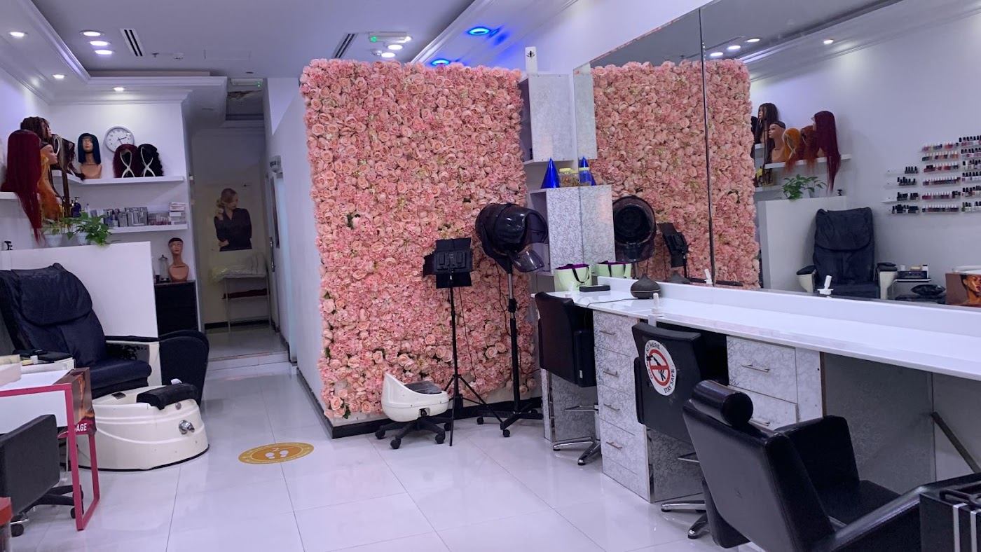Inside Justice Beauty Saloon with its pink rose wall and styling stations